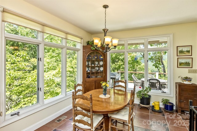 25 Windsong Dr, Fairview, NC 28730 - dining space with tile patterned floors, plenty of natural light, a chandelier, and baseboards