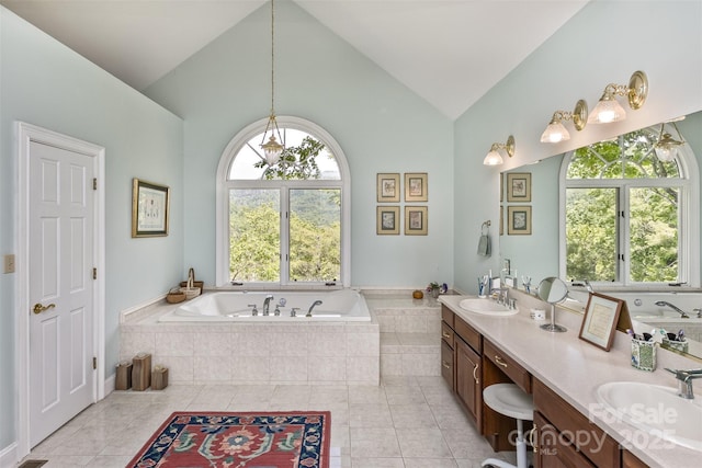 25 Windsong Dr, Fairview, NC 28730 - full bath with a garden tub, double vanity, plenty of natural light, tile patterned flooring, and high vaulted ceiling