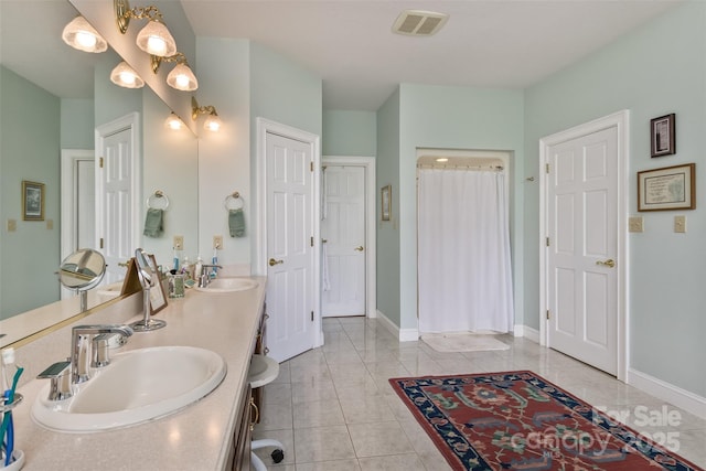 25 Windsong Dr, Fairview, NC 28730 - full bath with a shower with curtain, double vanity, baseboards, and tile patterned flooring