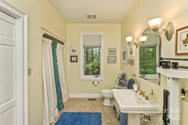 25 Windsong Dr, Fairview, NC 28730 - bathroom with toilet, tile patterned floors, baseboards, a sink, and curtained shower