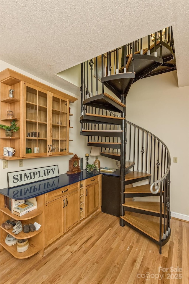 25 Windsong Dr, Fairview, NC 28730 - bar area featuring light wood-type flooring, stairway, baseboards, and a textured ceiling