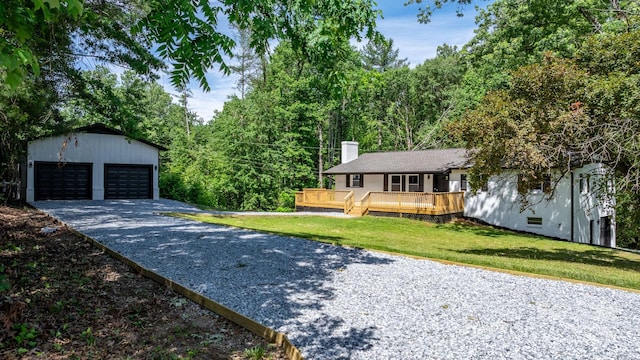 520 Hickory Ave, Hudson, NC 28638 - view of front of house featuring an outdoor structure, a garage, a chimney, a front lawn, and a deck