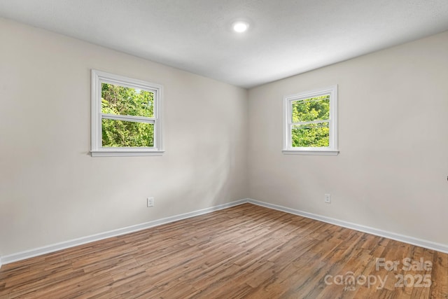 520 Hickory Ave, Hudson, NC 28638 - spare room featuring baseboards, healthy amount of natural light, wood finished floors, and recessed lighting