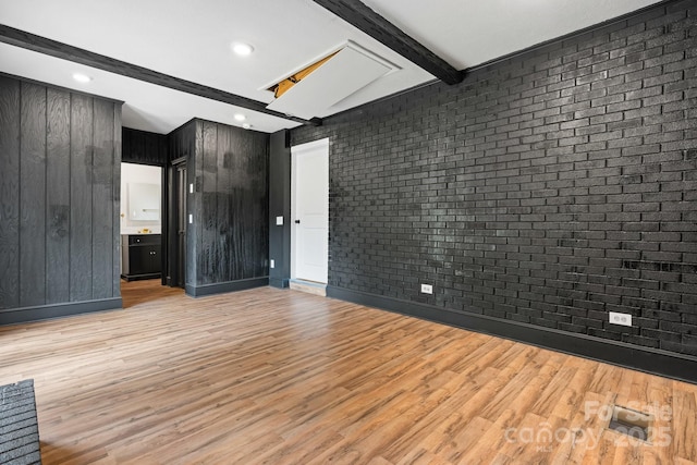 520 Hickory Ave, Hudson, NC 28638 - spare room with beam ceiling, light wood-style flooring, brick wall, and recessed lighting
