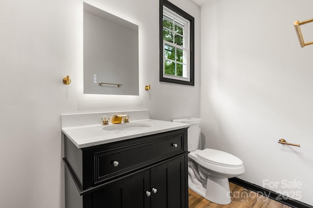 520 Hickory Ave, Hudson, NC 28638 - bathroom with toilet, vanity, and wood finished floors