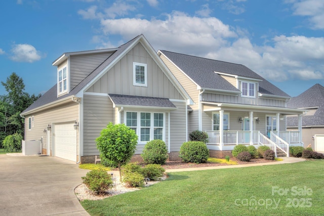 1327 Springlake Rd, York, SC 29745 - view of front of house featuring board and batten siding, driveway, an attached garage, covered porch, and a front lawn