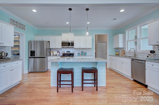 1327 Springlake Rd, York, SC 29745 - kitchen featuring stainless steel appliances, a sink, decorative backsplash, white cabinetry, and ornamental molding