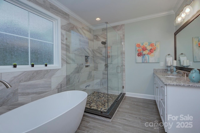 1327 Springlake Rd, York, SC 29745 - bathroom featuring a shower stall, vanity, crown molding, a freestanding bath, and baseboards