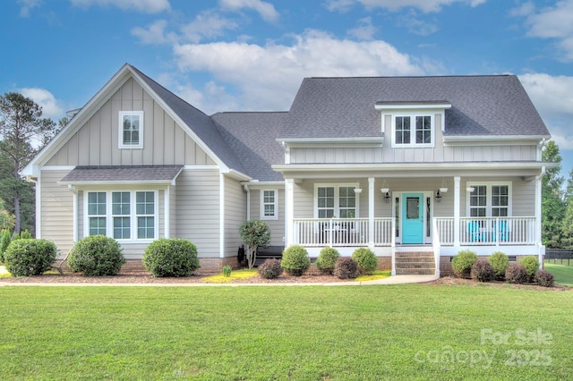 1327 Springlake Rd, York, SC 29745 - view of front of home with board and batten siding, a front lawn, covered porch, and roof with shingles