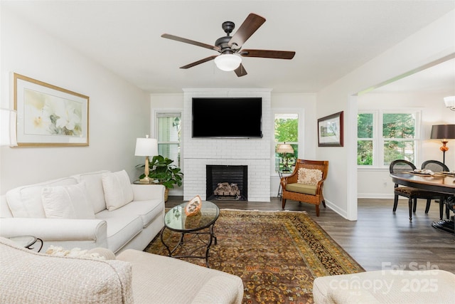 1041 Brawley School Rd, Mooresville, NC 28117 - living room featuring wood finished floors, ceiling fan, a fireplace, and baseboards