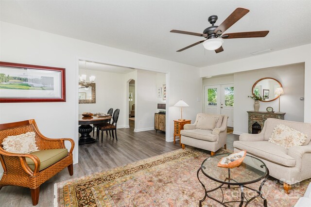 1041 Brawley School Rd, Mooresville, NC 28117 - living area with wood finished floors, a ceiling fan, arched walkways, and baseboards