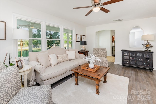 1041 Brawley School Rd, Mooresville, NC 28117 - living room featuring a ceiling fan, wood finished floors, and arched walkways
