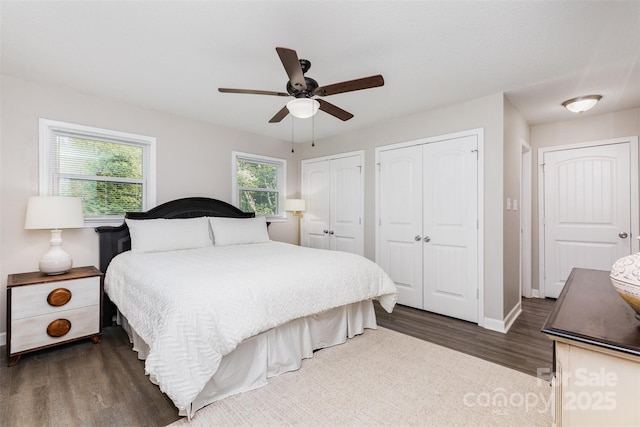 1041 Brawley School Rd, Mooresville, NC 28117 - bedroom with multiple closets, dark wood-style flooring, baseboards, and a ceiling fan