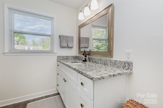 1041 Brawley School Rd, Mooresville, NC 28117 - bathroom featuring healthy amount of natural light, baseboards, vanity, and wood finished floors