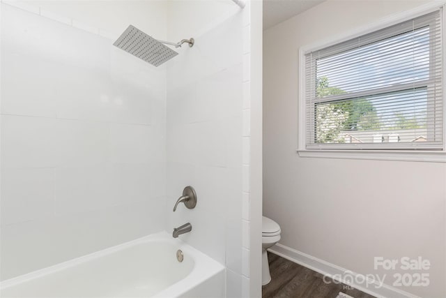 1041 Brawley School Rd, Mooresville, NC 28117 - bathroom featuring toilet, wood finished floors, baseboards, and shower / bathtub combination