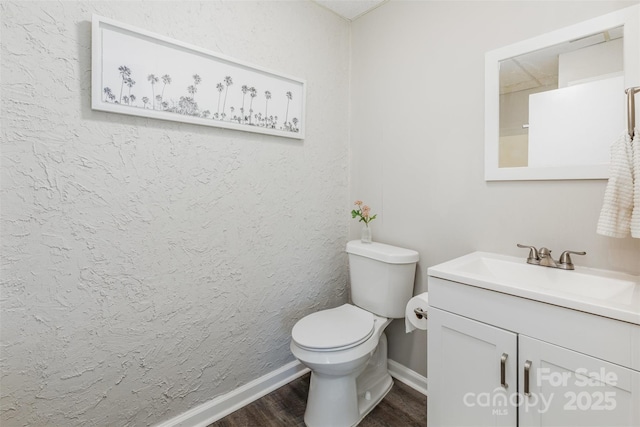 1041 Brawley School Rd, Mooresville, NC 28117 - bathroom with wood finished floors, toilet, vanity, and baseboards