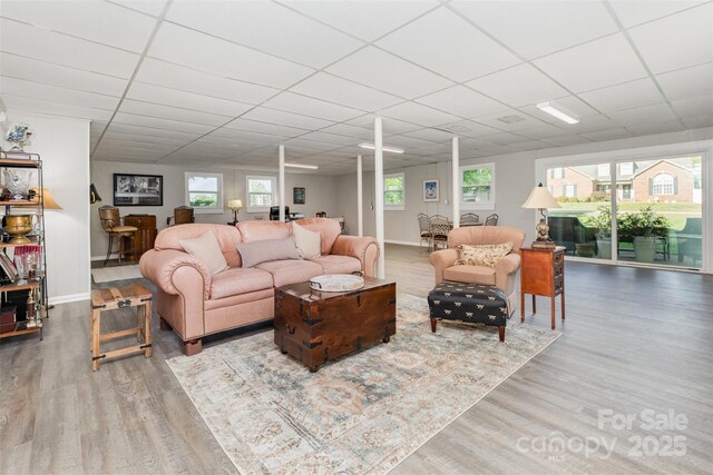 1041 Brawley School Rd, Mooresville, NC 28117 - living room with a drop ceiling, wood finished floors, baseboards, and plenty of natural light