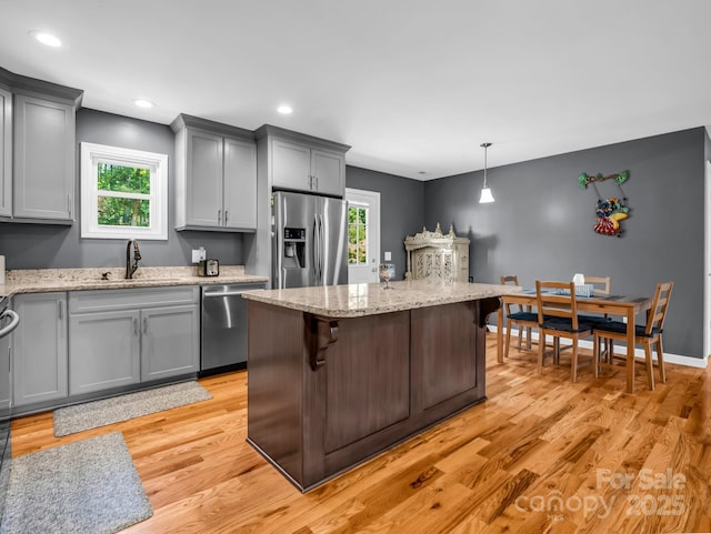 2301 Saratoga Run, Morganton, NC 28655 - kitchen with appliances with stainless steel finishes, a sink, gray cabinets, light stone countertops, and light wood-style floors