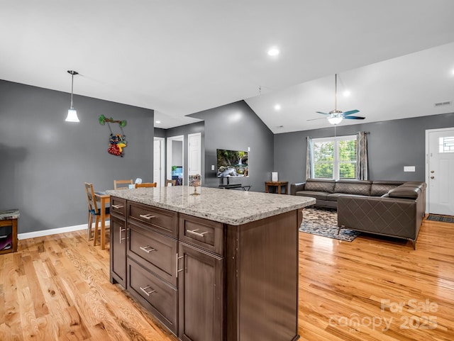 2301 Saratoga Run, Morganton, NC 28655 - kitchen with light wood-type flooring, a kitchen island, a ceiling fan, decorative light fixtures, and lofted ceiling
