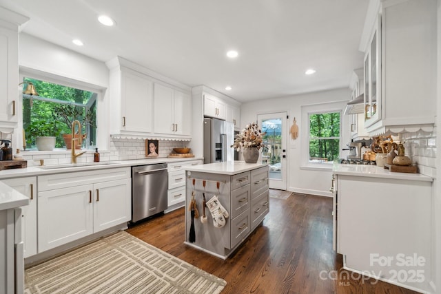 2507 Connemara Dr, Matthews, NC 28105 - kitchen with stainless steel appliances, a sink, decorative backsplash, light countertops, and recessed lighting