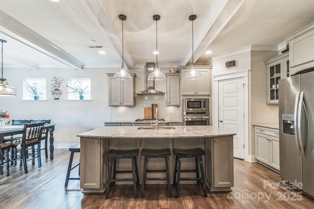 2112 Balting Glass Dr, Indian Trail, NC 28079 - kitchen featuring stainless steel appliances, wall chimney range hood, beamed ceiling, a breakfast bar, and tasteful backsplash