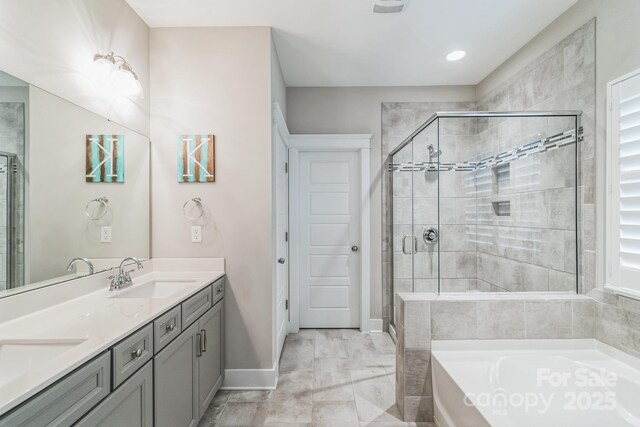2112 Balting Glass Dr, Indian Trail, NC 28079 - bathroom featuring a stall shower, a garden tub, baseboards, double vanity, and marble look tile flooring