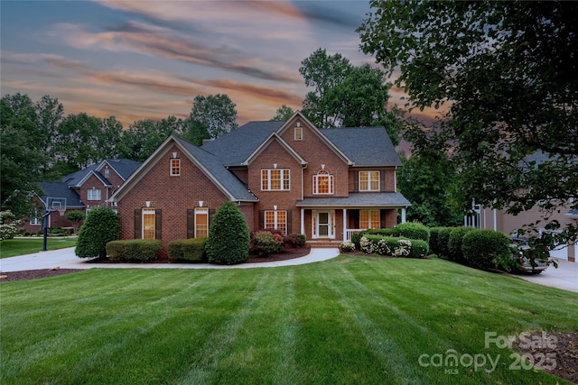 132 Parkside Ln, Mooresville, NC 28117 - view of front of property featuring brick siding, a lawn, and covered porch