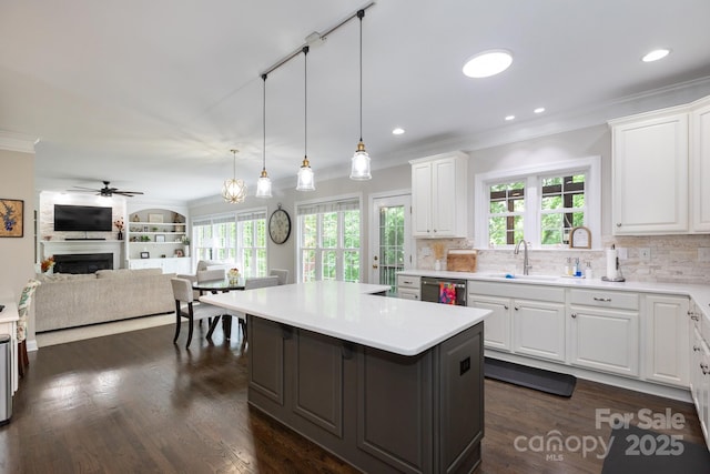 132 Parkside Ln, Mooresville, NC 28117 - kitchen with stainless steel dishwasher, ornamental molding, decorative backsplash, white cabinets, and recessed lighting