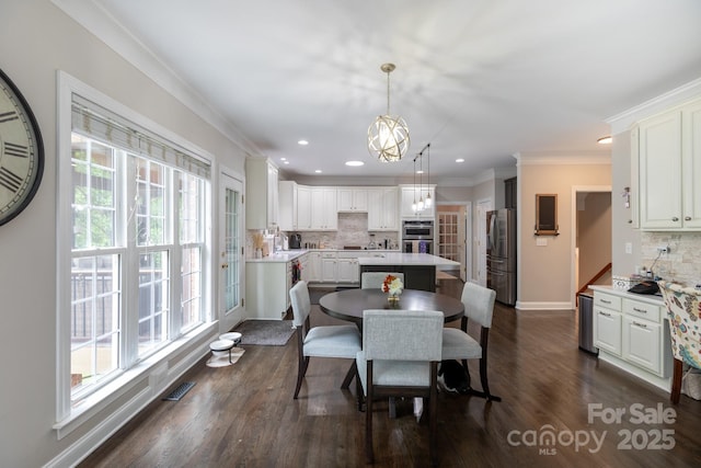 132 Parkside Ln, Mooresville, NC 28117 - dining room with plenty of natural light, baseboards, dark wood-type flooring, recessed lighting, and crown molding