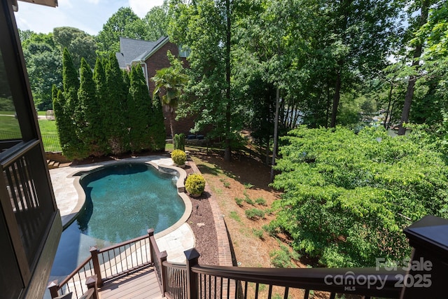 132 Parkside Ln, Mooresville, NC 28117 - view of swimming pool with view of wooded area and a wooden deck