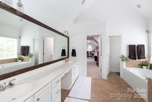 132 Parkside Ln, Mooresville, NC 28117 - bathroom with double vanity, a bath, plenty of natural light, high vaulted ceiling, and tile patterned flooring