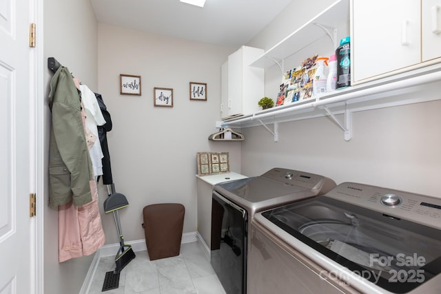 132 Parkside Ln, Mooresville, NC 28117 - laundry room with washing machine and dryer, cabinet space, baseboards, and light marble finish flooring