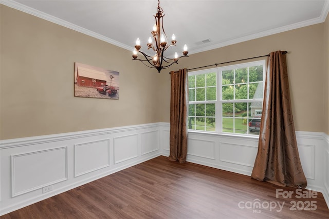 417 Brier Knob Dr, Fort Mill, SC 29715 - unfurnished room with a chandelier, ornamental molding, wainscoting, dark wood-style flooring, and a decorative wall