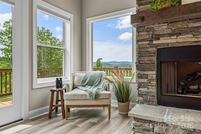 552 High Trail Dr, Nebo, NC 28761 - sitting room featuring wood finished floors, a mountain view, a fireplace, and plenty of natural light