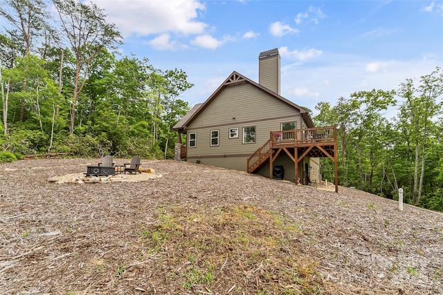 552 High Trail Dr, Nebo, NC 28761 - back of property featuring a deck, stairway, a fire pit, and a chimney