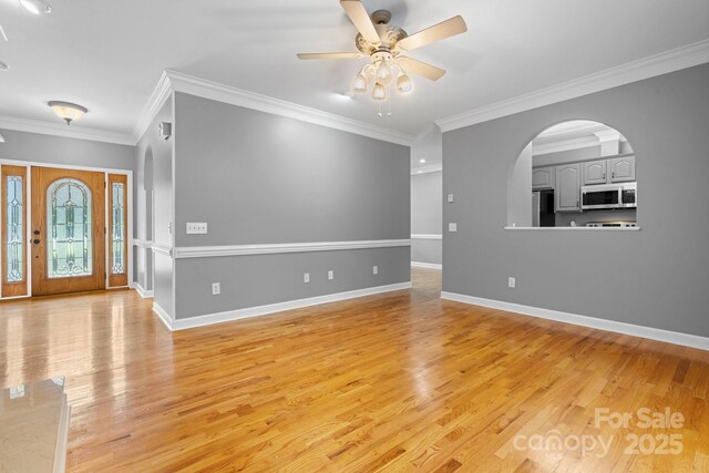 5362 Beacon Ridge Dr, Granite Falls, NC 28630 - empty room featuring light wood-style floors, a ceiling fan, baseboards, ornamental molding, and arched walkways