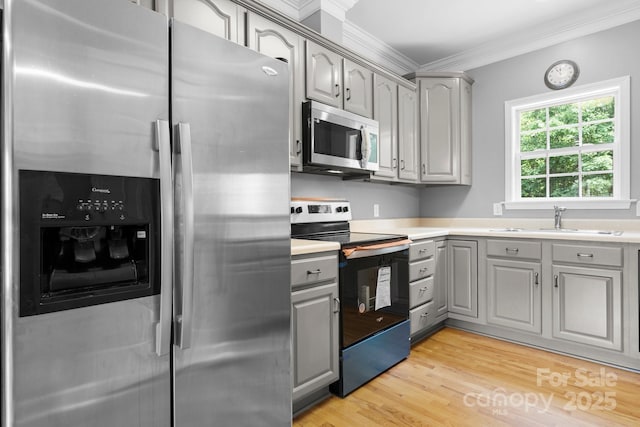 5362 Beacon Ridge Dr, Granite Falls, NC 28630 - kitchen with appliances with stainless steel finishes, gray cabinetry, a sink, crown molding, and light wood-style floors