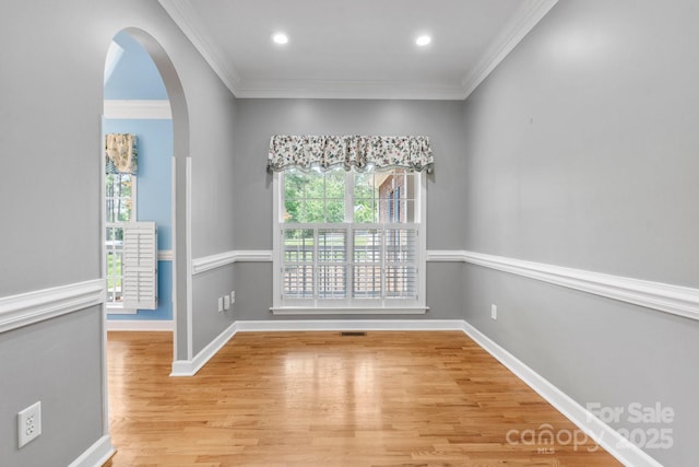 5362 Beacon Ridge Dr, Granite Falls, NC 28630 - empty room featuring arched walkways, light wood-style floors, crown molding, baseboards, and recessed lighting