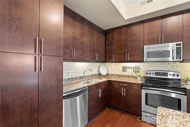 4620 Piedmont Row Dr Unit 308, Charlotte, NC 28210 - kitchen with appliances with stainless steel finishes, light stone counters, a sink, and backsplash