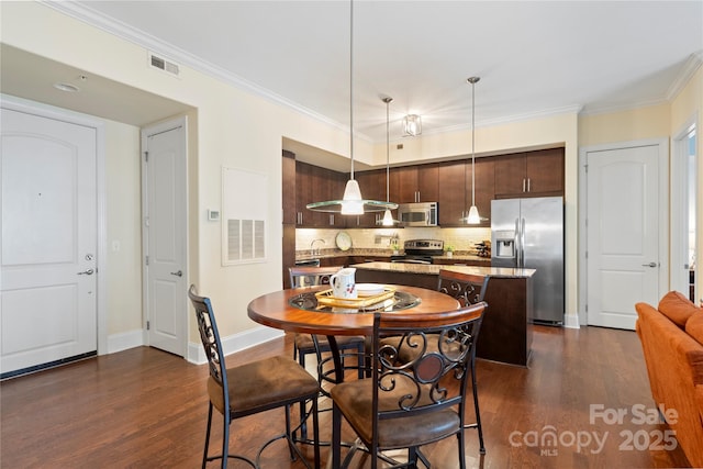 4620 Piedmont Row Dr Unit 308, Charlotte, NC 28210 - dining space with dark wood finished floors, ornamental molding, and baseboards
