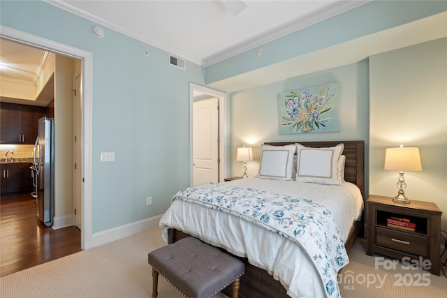 4620 Piedmont Row Dr Unit 308, Charlotte, NC 28210 - bedroom with freestanding refrigerator, crown molding, baseboards, and wood finished floors