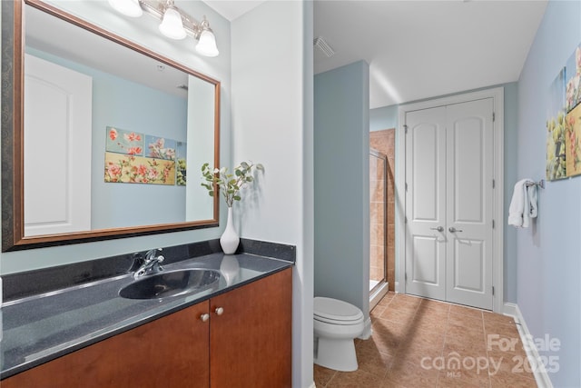 4620 Piedmont Row Dr Unit 308, Charlotte, NC 28210 - full bathroom with a stall shower, toilet, vanity, tile patterned floors, and baseboards