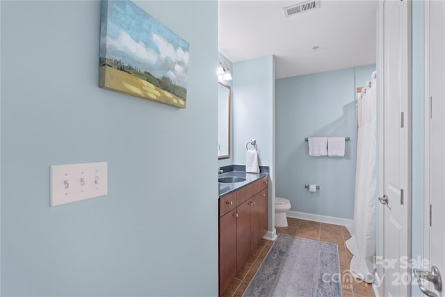 4620 Piedmont Row Dr Unit 308, Charlotte, NC 28210 - full bathroom featuring toilet, vanity, tile patterned floors, and baseboards