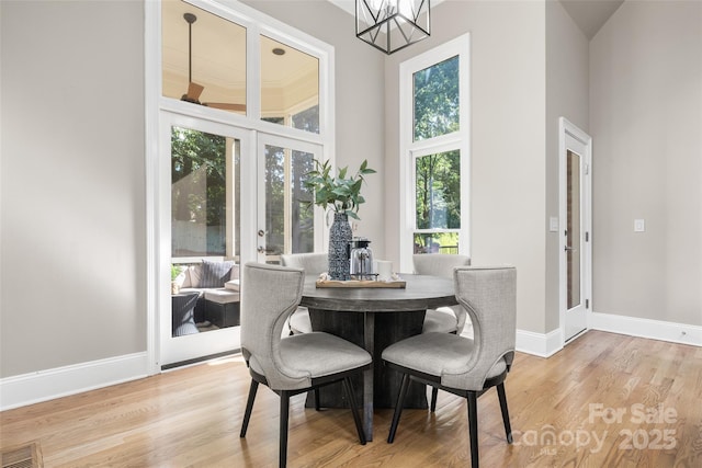 9219 Whispering Wind Dr, Charlotte, NC 28277 - dining room with wood finished floors, baseboards, a chandelier, and french doors