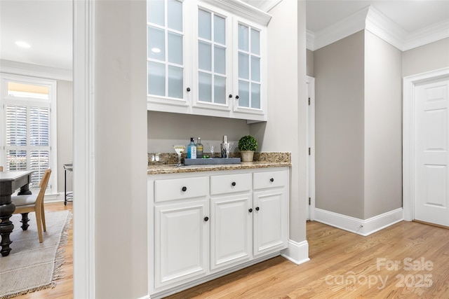 9219 Whispering Wind Dr, Charlotte, NC 28277 - indoor dry bar featuring light wood-style floors, crown molding, and baseboards