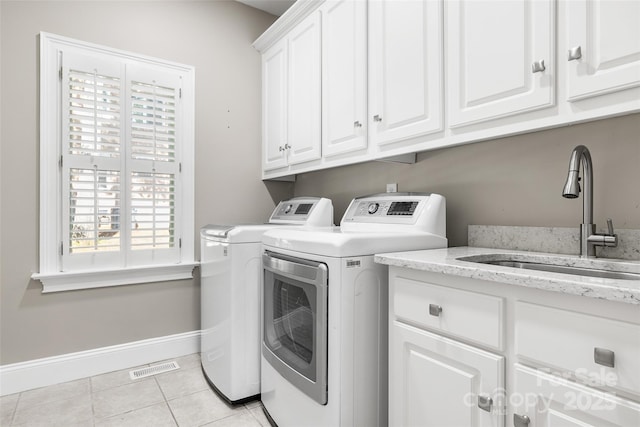 9219 Whispering Wind Dr, Charlotte, NC 28277 - washroom featuring washer and dryer, cabinet space, baseboards, and light tile patterned flooring