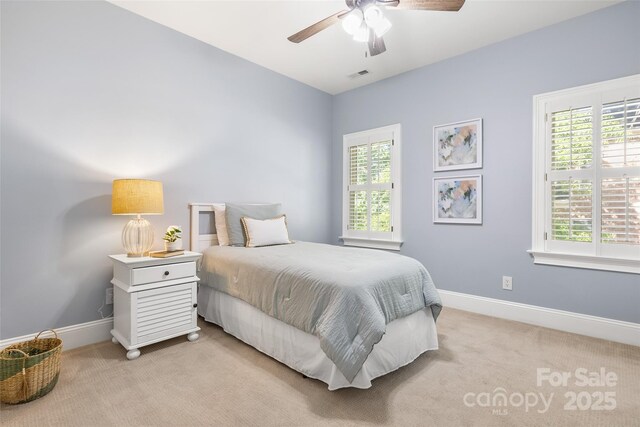 9219 Whispering Wind Dr, Charlotte, NC 28277 - bedroom with light colored carpet, multiple windows, baseboards, and a ceiling fan