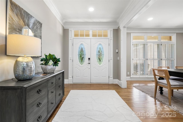 9219 Whispering Wind Dr, Charlotte, NC 28277 - foyer featuring crown molding, healthy amount of natural light, wood finished floors, baseboards, and recessed lighting