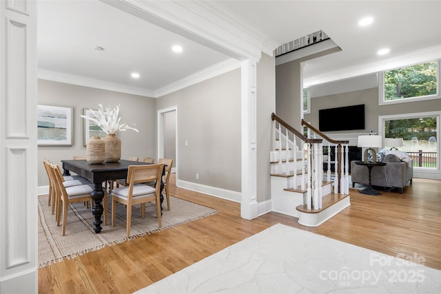 9219 Whispering Wind Dr, Charlotte, NC 28277 - dining area with wood finished floors, crown molding, baseboards, stairs, and recessed lighting