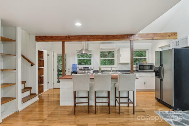 291 Dills Rd, Bryson City, NC 28713 - kitchen featuring appliances with stainless steel finishes, white cabinets, light wood-style flooring, healthy amount of natural light, and recessed lighting